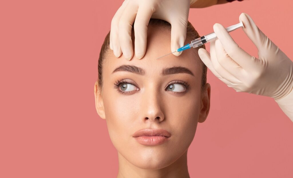 Pretty young lady getting Injection on her forehead | Get botox in The Botox Bar and Aesthetics at Dallas & Sherman, TX