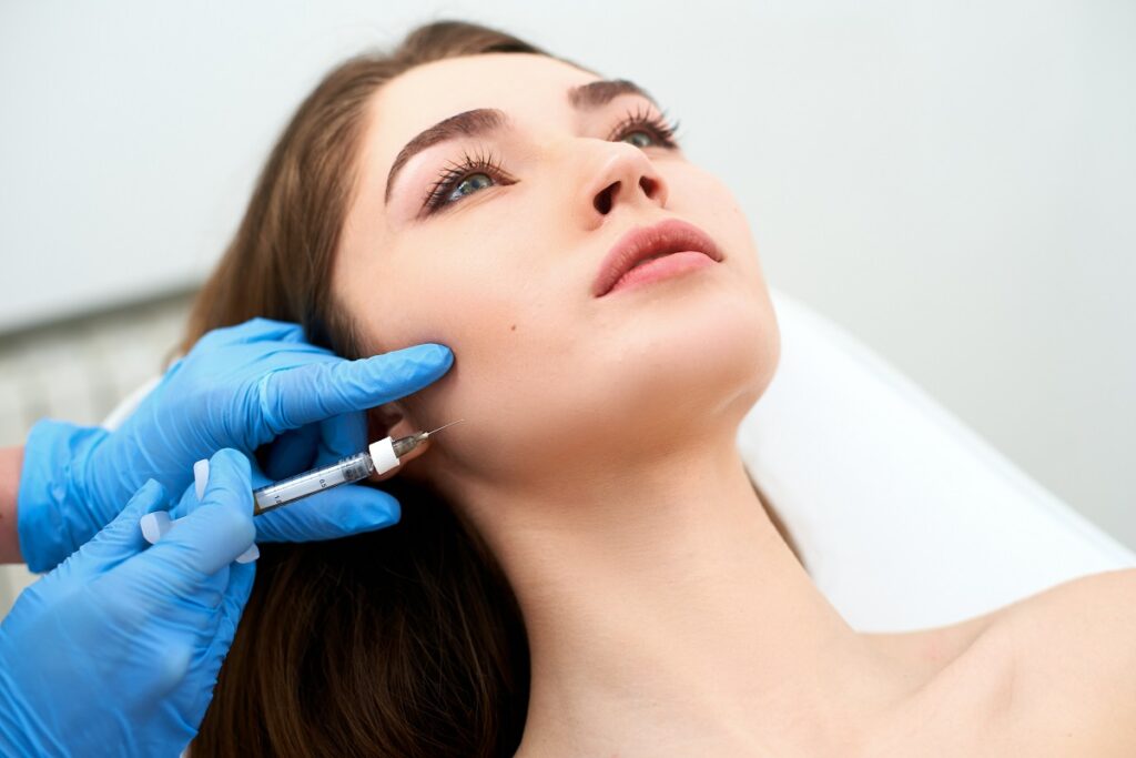 Beautiful girl receiving Injection on cheeks | Get Sculptra in The Botox Bar and Aesthetics at Dallas & Sherman, TX